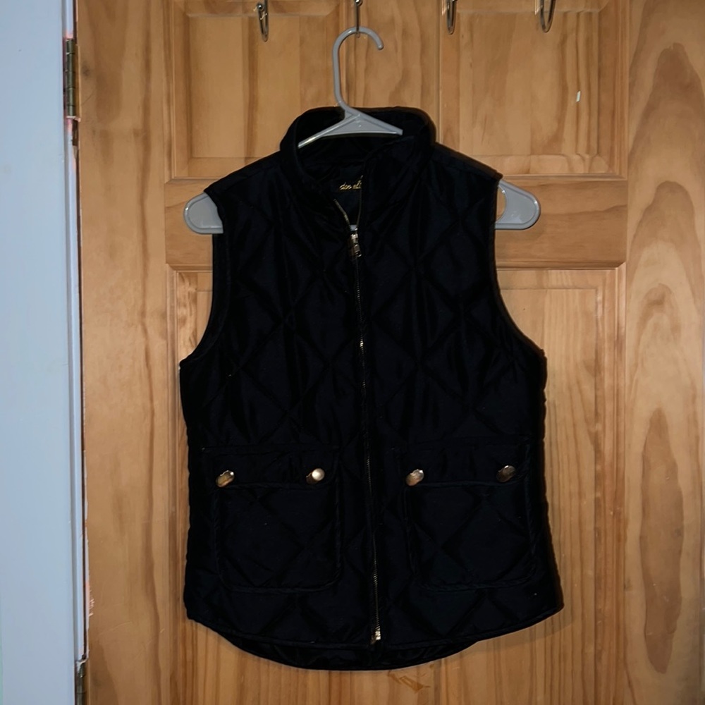 Black vest with gold detailing.